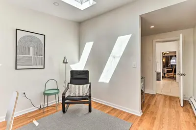 a living room with a chair and a window at Philadelphia Home Rental Near Center City! in Philadelphia