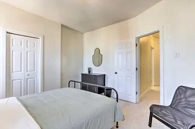 a bedroom with a bed and a chair and a mirror at Philadelphia Home Rental Near Center City! in Philadelphia