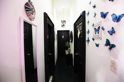 a hallway with blue butterflies on the walls at Beautiful and spacious apartment in Times Square! in New York