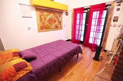 a bedroom with a purple bed and red curtains at Beautiful and spacious apartment in Times Square! in New York