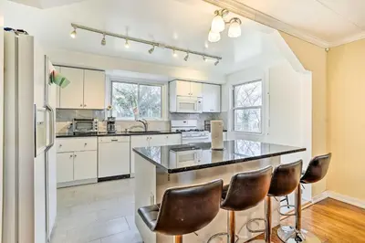 a kitchen with white cabinets and a black counter top at Family Vacation Rental 18 Mi to Philadelphia in Gibbstown