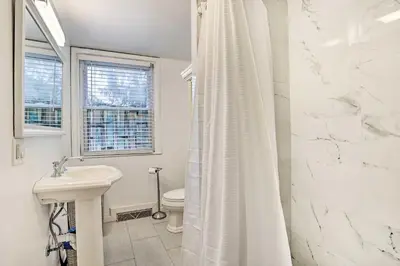 a white bathroom with a sink and a toilet at Family Vacation Rental 18 Mi to Philadelphia in Gibbstown