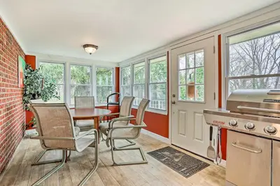 a kitchen with a table and chairs and windows at Family Vacation Rental 18 Mi to Philadelphia in Gibbstown