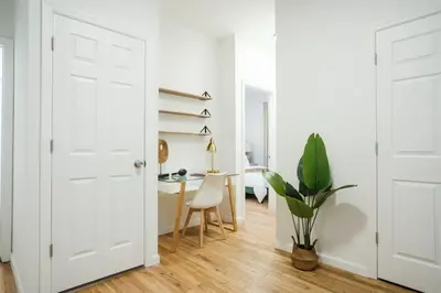 a white room with a desk and a white door at 74-4A 2BR 2baths in Prime Upper West Side w d GYM in New York