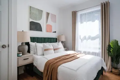 a bedroom with a large bed and a window at 74-4A 2BR 2baths in Prime Upper West Side w d GYM in New York