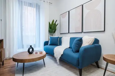 a living room with a blue couch and a table at 74-4A 2BR 2baths in Prime Upper West Side w d GYM in New York
