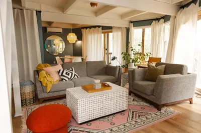a living room with two couches and a table at Lake Naomi Chalet - 2hrs from NYC in Pocono Pines