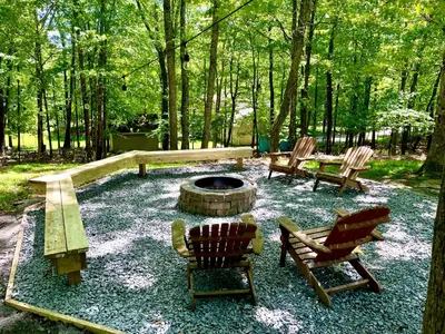 two chairs and a fire pit in a yard at AMAZING Home with PRIVATE POOL, GAME ROOM & FIRE PIT! in East Stroudsburg