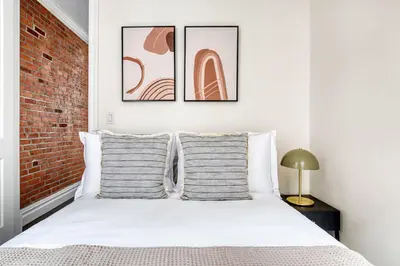 a bedroom with a white bed with two pillows at Nolita 1br w wd nr New Museum NYC-1037 in New York