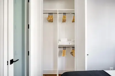 a bedroom with a closet with white walls at West Village 3br w wd nr Pier 46 NYC-1098 in New York