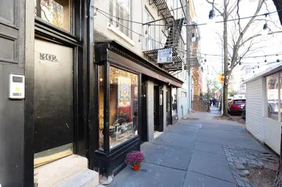 a city street with a store window with a flower pot at West Village 3br w wd nr Pier 46 NYC-1098 in New York