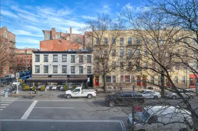 a city street with cars parked in front of buildings at West Village 3br w wd nr Pier 46 NYC-1098 in New York