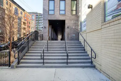 a staircase leading to a building with a tunnel at Hoboken 2BR w PATH Shuttle Gym WD NYC-813 in Hoboken