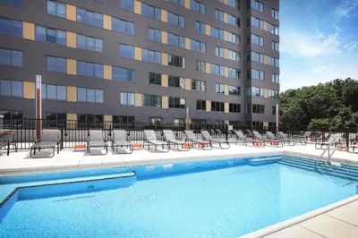 a swimming pool in front of a building at Hoboken 2BR w PATH Shuttle Gym WD NYC-813 in Hoboken