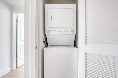 a white laundry room with a washer and dryer at Jersey City 2BR w wd roof gym nr Path NYC-962 in Jersey City