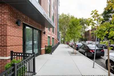 a sidewalk in front of a brick building at Jersey City 2BR w wd roof gym nr Path NYC-962 in Jersey City