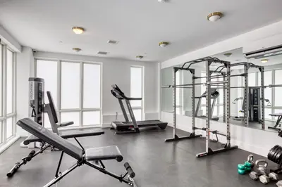 a gym with treadmills and elliptical machines at Jersey City 2BR w wd roof gym nr Path NYC-962 in Jersey City