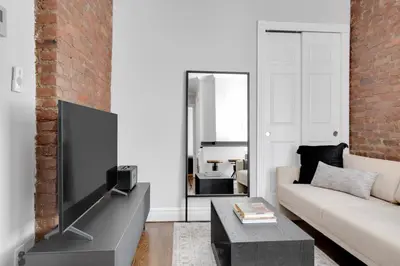 a living room with a large flat screen tv at E Village 1BR w in-unit WD nr Park NYC-722 in New York