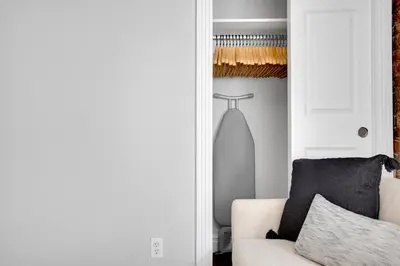 a living room with a white couch and a closet at E Village 1BR w in-unit WD nr Park NYC-722 in New York