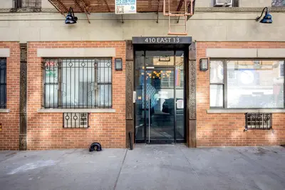 an entrance to a brick building with a glass door at E Village 1BR w in-unit WD nr Park NYC-722 in New York