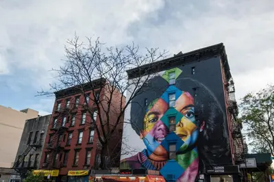a large mural of a woman on the side of a building at E Village 1BR w in-unit WD nr Park NYC-722 in New York