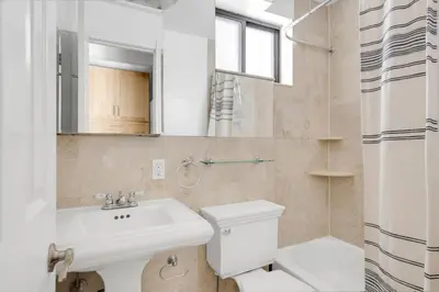 a bathroom with a sink and a toilet and a mirror at E Village 1BR w in-unit WD nr Park NYC-722 in New York