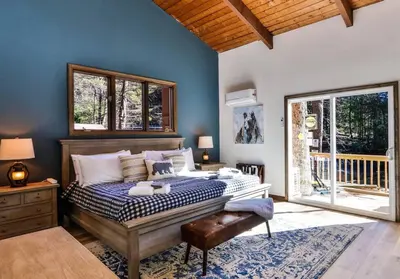 a bedroom with a bed with a blue wall at Poconos Pool Paradise in East Stroudsburg