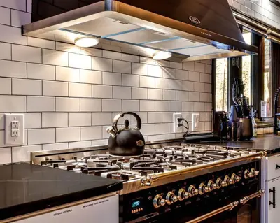 a kitchen with a stove with a tea kettle on it at Poconos Pool Paradise in East Stroudsburg
