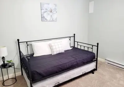 a black bed with white pillows in a room at The Family Getaway in Tobyhanna