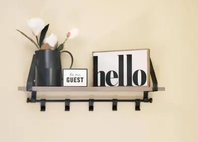 a shelf with a vase and two pictures on it at The Family Getaway in Tobyhanna