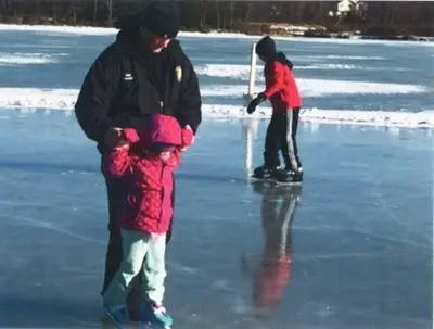 a man and two children playing on the ice at The Family Getaway in Tobyhanna
