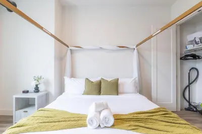 a bedroom with a white bed with towels on it at Emerald Escape, Free Parking, 2 Bath, Sleeps 8 Near American Dream and The Airport, King Bed and 2 Queen Beds, Washer and Dryer in Orange