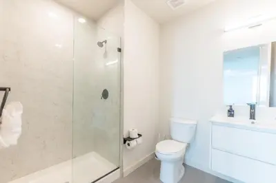 a bathroom with a shower and a toilet and a sink at Emerald Escape, Free Parking, 2 Bath, Sleeps 8 Near American Dream and The Airport, King Bed and 2 Queen Beds, Washer and Dryer in Orange