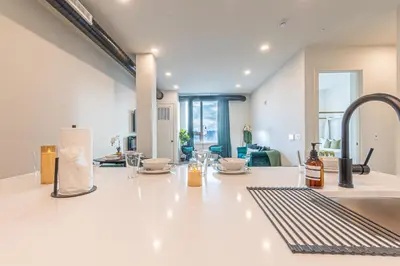 a kitchen with a white counter top and a sink at Emerald Escape, Free Parking, 2 Bath, Sleeps 8 Near American Dream and The Airport, King Bed and 2 Queen Beds, Washer and Dryer in Orange
