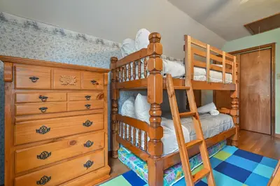 a bedroom with two bunk beds and a dresser at Wolf Hollow Harmony in Lake Harmony