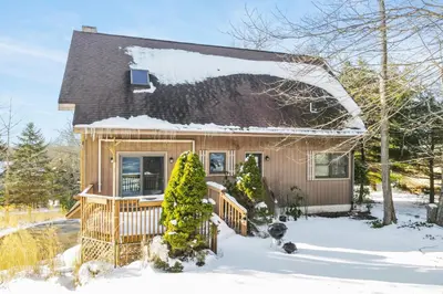 a small house with snow on the roof at Wolf Hollow Harmony in Lake Harmony