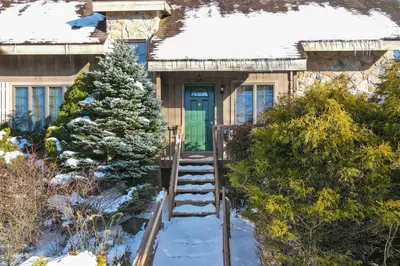 a house with a christmas tree in the snow at Wolf Hollow Harmony in Lake Harmony