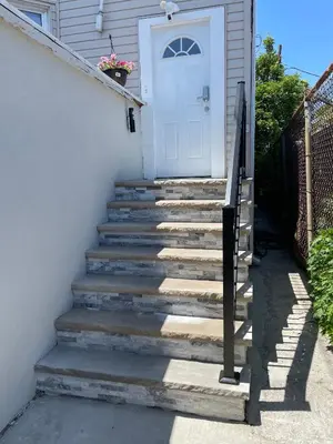 a set of stairs leading to a white door at New York City Private Bedroom Near The Free Ferry Boat! in Stapleton