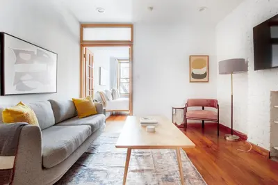 a living room with a couch and a table at Nolita 2br w wd nr SoHo NYC-992 in New York