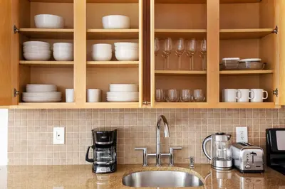 a kitchen counter with a sink and cups and dishes at Nolita 2br w wd nr SoHo NYC-992 in New York