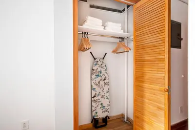 a tie hanging on a wall next to a closet at Nolita 2br w wd nr SoHo NYC-992 in New York