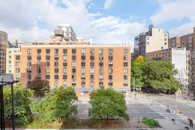 a large brick building in the middle of a city at Nolita 2br w wd nr SoHo NYC-992 in New York