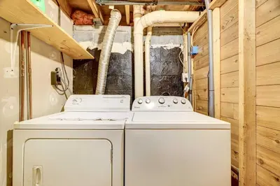 a washer and dryer in a tiny house at Pocono Vacation Rental with Game Room! in Tobyhanna