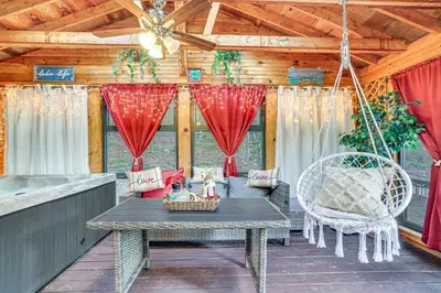 a porch with a table and chairs and a ceiling at Pocono Vacation Rental with Game Room! in Tobyhanna