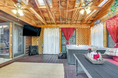 a living room with a couch and a table at Pocono Vacation Rental with Game Room! in Tobyhanna