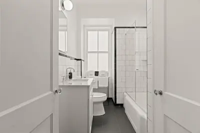 a white bathroom with a sink and a toilet at Stay Rafa At 2000 Spruce in Philadelphia