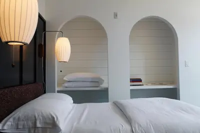 a bedroom with a bed and two arched windows at Stay Rafa At 2000 Spruce in Philadelphia