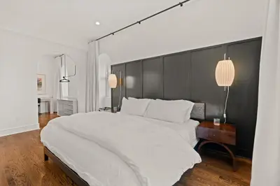a bedroom with a large white bed with a black headboard at Stay Rafa At 2000 Spruce in Philadelphia
