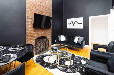 a living room with a couch and a fireplace at Spacious studio in Brooklyn Heights in Brooklyn