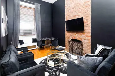 a living room with a couch and a fireplace at Spacious studio in Brooklyn Heights in Brooklyn